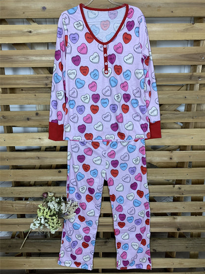 Family matching heart print pyjamas set, perfect for Valentine's Day, with long-sleeve top and trousers made from soft cotton blend.
