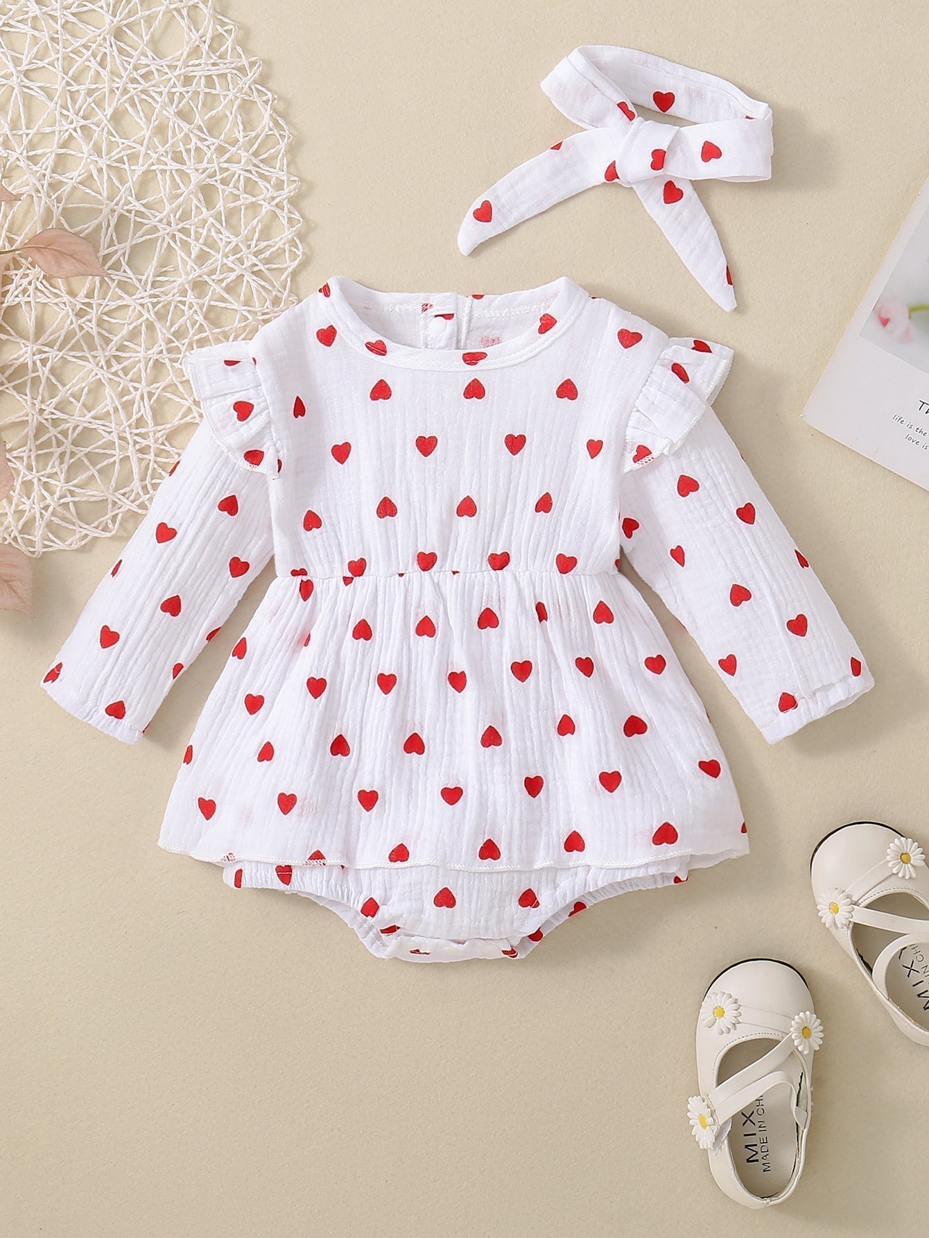 Adorable baby girl Valentine's Day dress with heart pattern, white long-sleeve, cotton fabric.