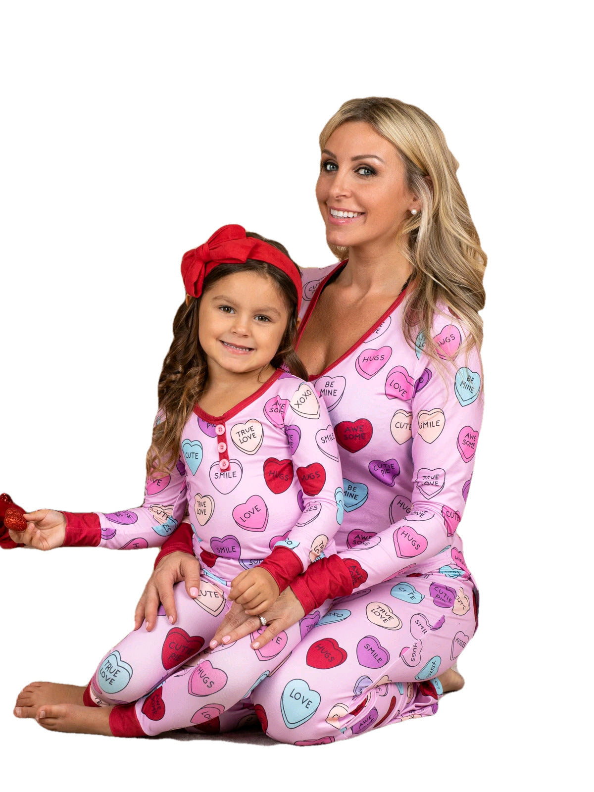 Adorable family matching heart print pyjamas for Valentine's Day celebration.