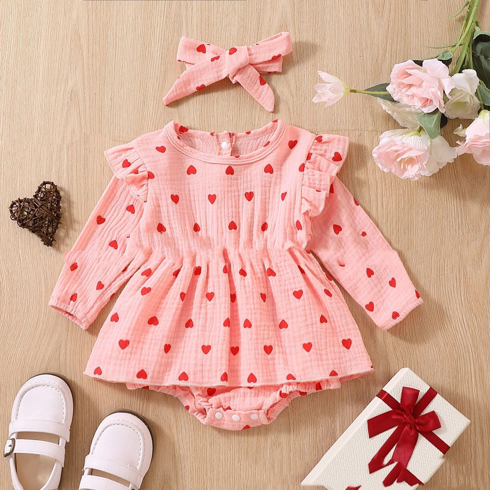 Adorable baby girl Valentine's Day dress with pink polka dot pattern and long sleeves.