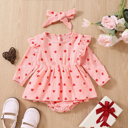 Adorable baby girl Valentine's Day dress with pink polka dot pattern and long sleeves.
