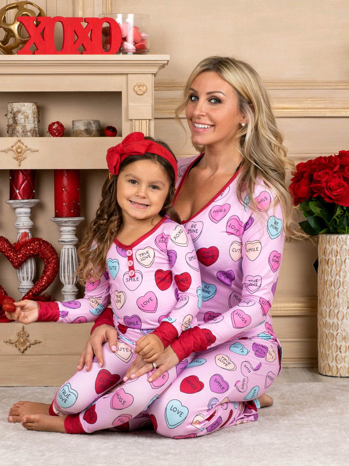 Adorable family in matching heart print pyjamas for Valentine's Day, featuring soft cotton blend and charming design.