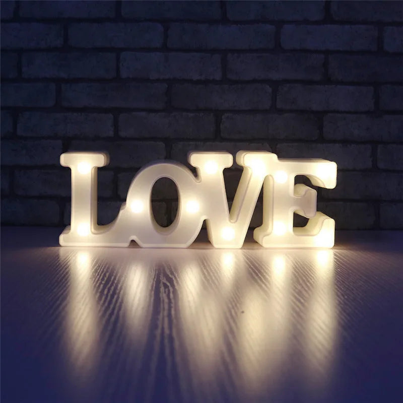 Love Heart LED Lamp with warm white light spelling "LOVE" in a dimly lit room.