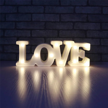 Love Heart LED Lamp with warm white light spelling "LOVE" in a dimly lit room.