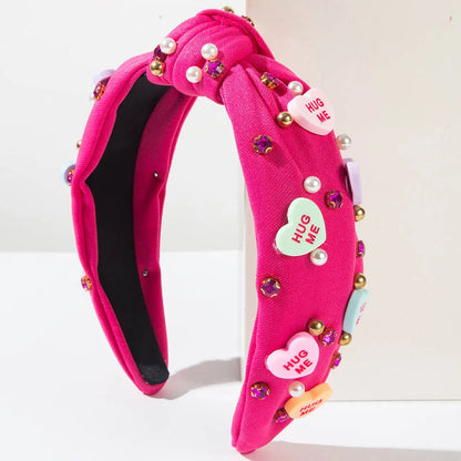 Pink Love Heart Pearl Knot Hairband with pearl and rhinestone embellishments, stylish and romantic headwear accessory.