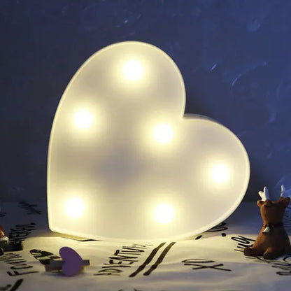 Love Heart LED Lamp emitting warm white light in a cozy setting, ideal for romantic and decorative occasions.