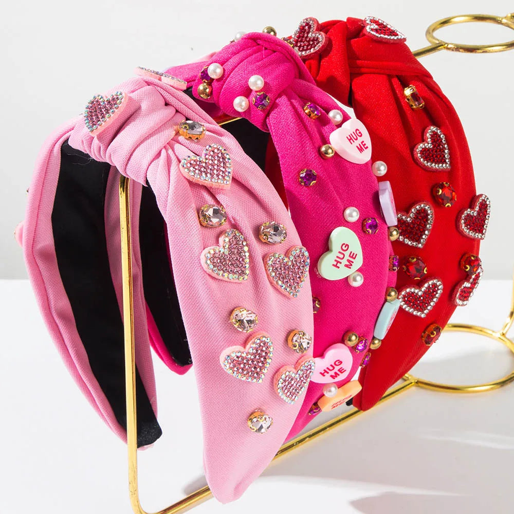 Pink Love Heart Pearl Knot Hairband with heart-shaped rhinestones on display.