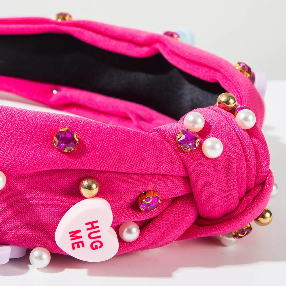 Pink Love Heart Pearl Knot Hairband with pearl and rhinestone embellishments, perfect for chic and romantic headwear.