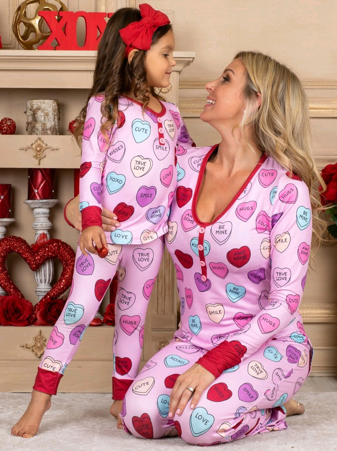 Adorable family matching heart print pyjamas for Valentine's Day, featuring soft cotton blend, long-sleeve T-shirt and trousers.