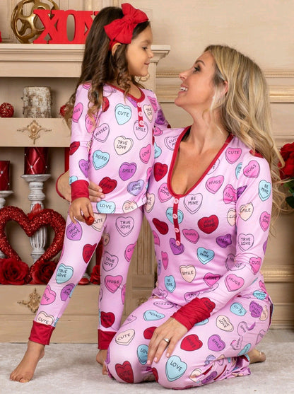 Adorable family matching heart print pyjamas for Valentine's Day, featuring soft cotton blend, long-sleeve T-shirt and trousers.